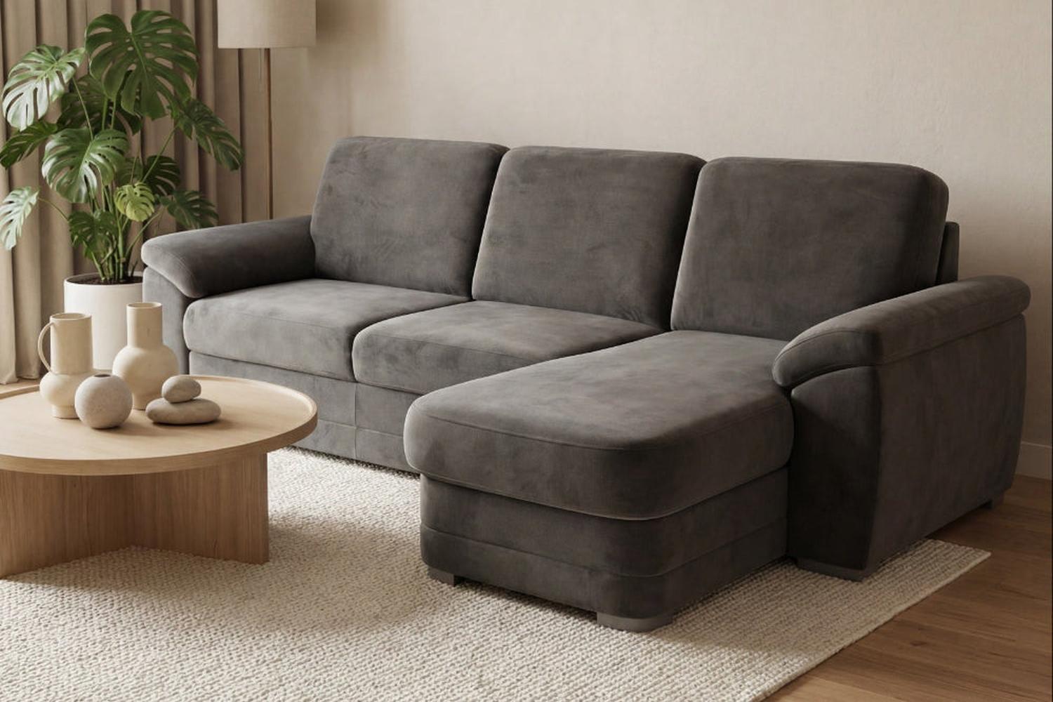 Gray sectional sofa in a living room with a wooden coffee table and decorative items.