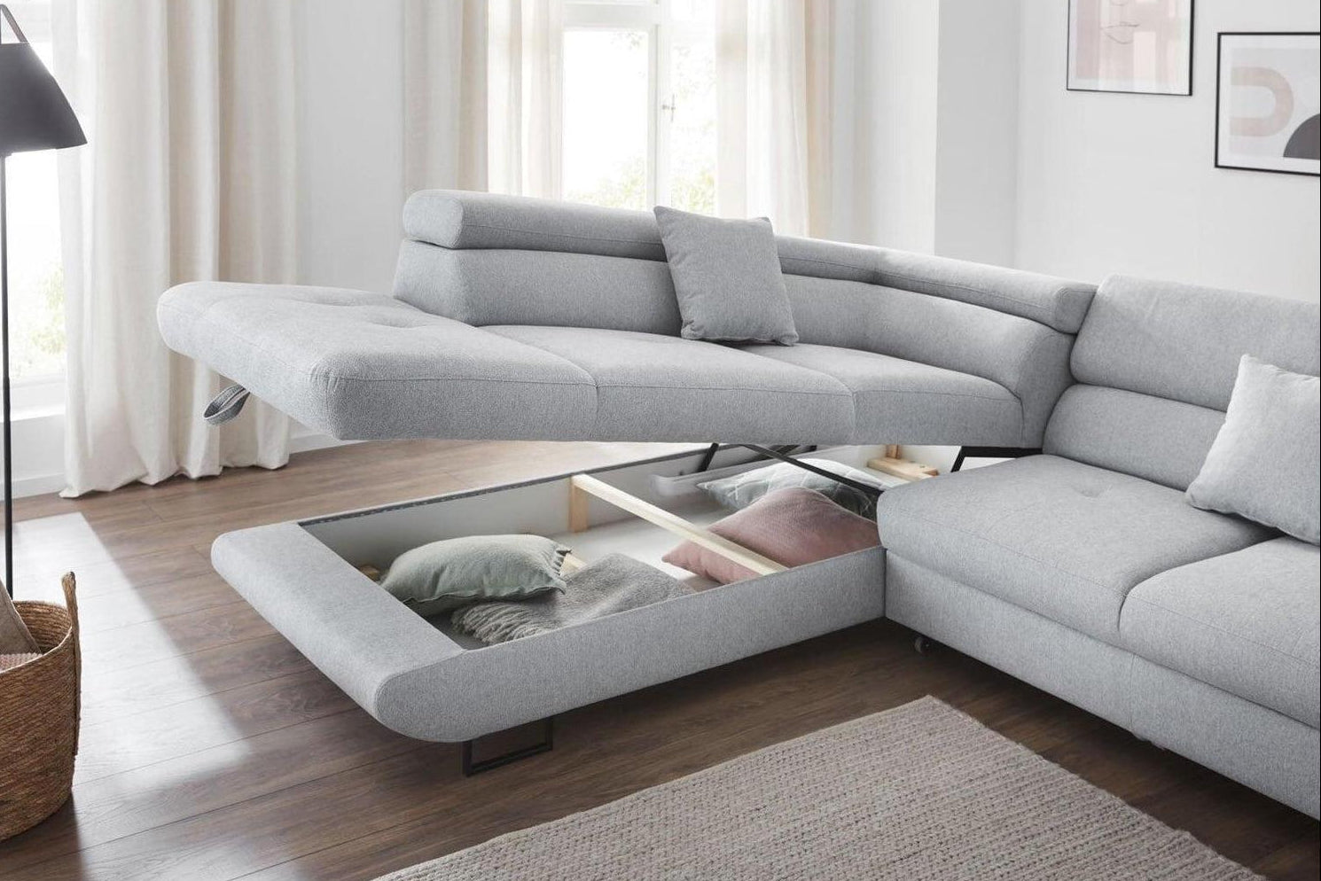 Gray sectional sofa with storage drawers in a living room setting