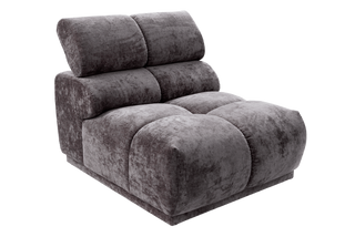 A modern low-profile lounge chair upholstered in a textured, crushed velvet fabric in a dark gray color, shown from a three-quarters angle on a plain white background.
