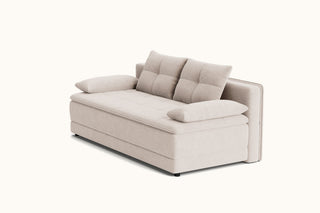 A modern upholstered sofa bed in a light beige fabric, featuring a tufted backrest with two cushions, matching side bolsters, and two loose throw pillows, shown on a plain off-white background.