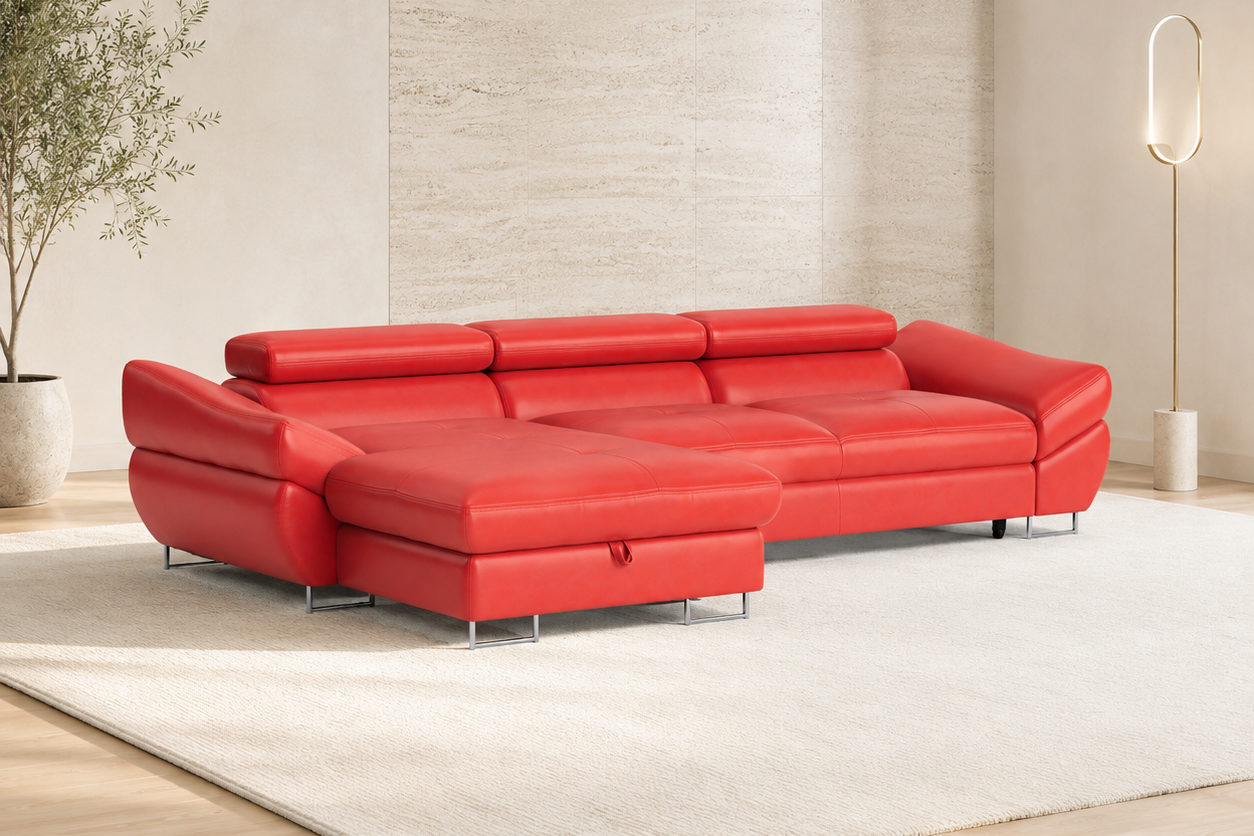 A bright red sectional sofa with a chaise lounge, shown in a modern living room setting with a light-colored rug, textured wall, and a floor lamp.