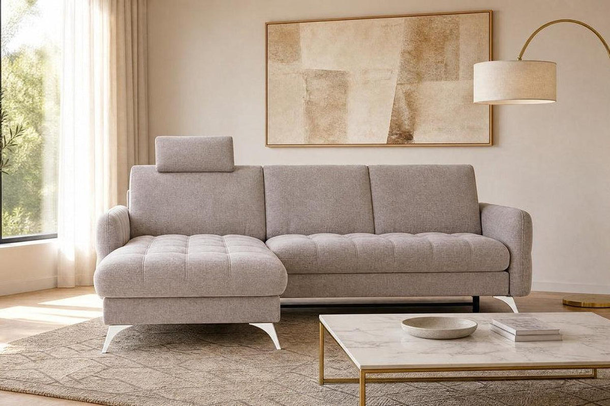 Modern living room with a gray sectional sofa, marble coffee table, and abstract art on the wall.