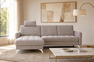 Modern living room with a gray sectional sofa, marble coffee table, and abstract art on the wall.