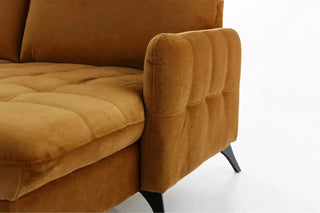 Brown sofa with tufted cushions on a white background